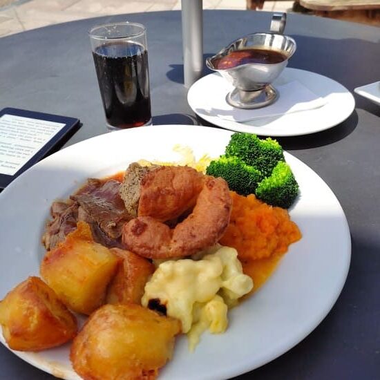 Plate with Sunday Roast and Kindle next to it
