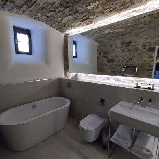 Modern bathroom with tub in converted cell, Bodmin Jail Hotel