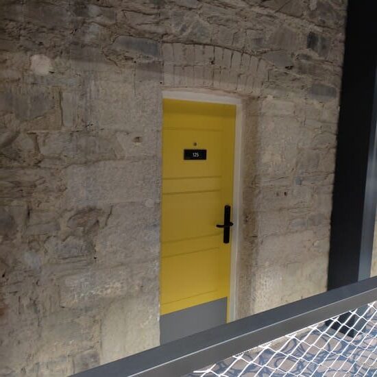 Yellow door to hotel room in former jail