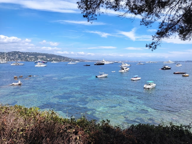 Bright blue Mediterranean Sea with white yachts of different sizes