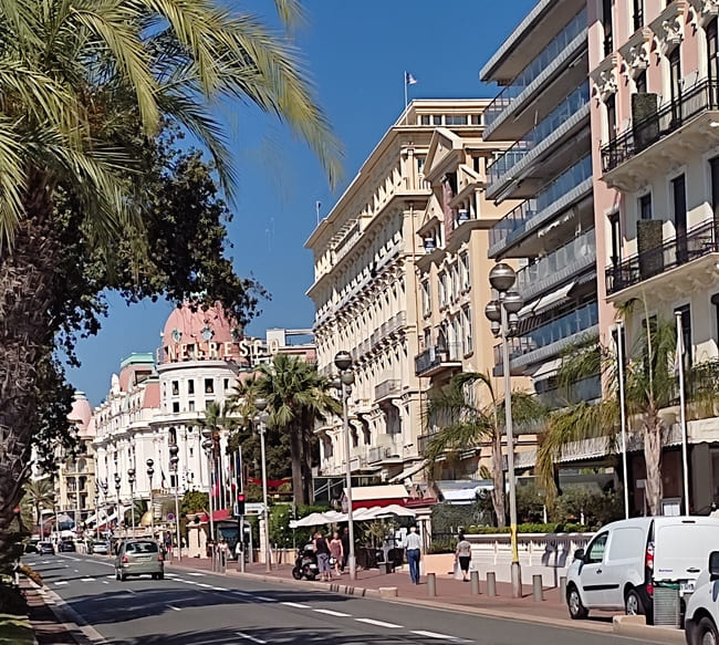 Large street in Nice, France, with the pink domed Hotel Negresco
