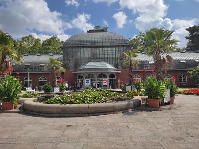 Building with green house dome at entrance of Palmengarten