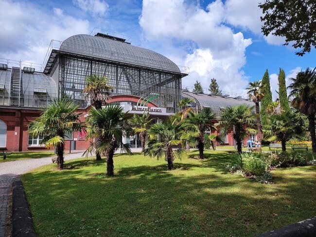 Building at entrance to Palmengarten, Frankfurt, with small palm trees in front of it