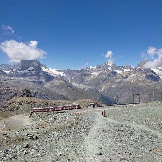 Impressive mountain scenery with cogwheel railway coming up Gornergrat in Zermatt