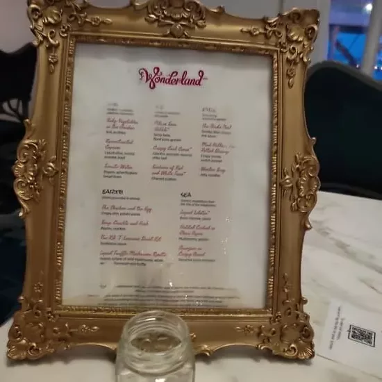 Golden frame with menu at Wonderland restaurant, included with Unlimited Dining plan