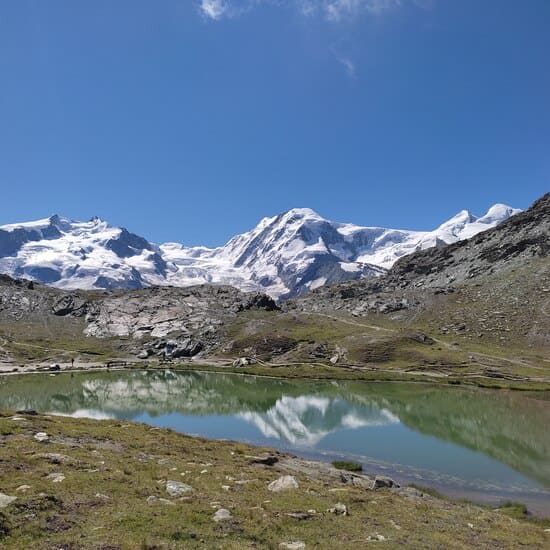 Snow-capped mountains refelcted in small lake