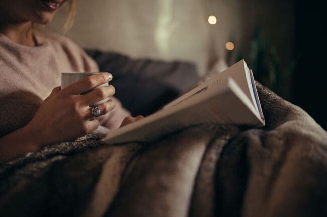 Woman at night relaxing with a book