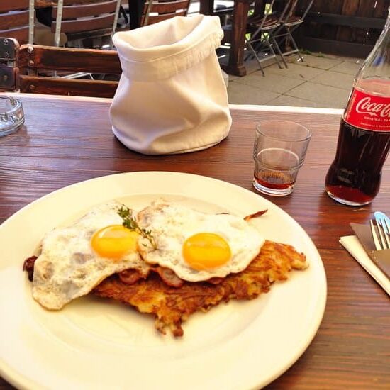 Plate with potato pancakes and sunny-side up eggs