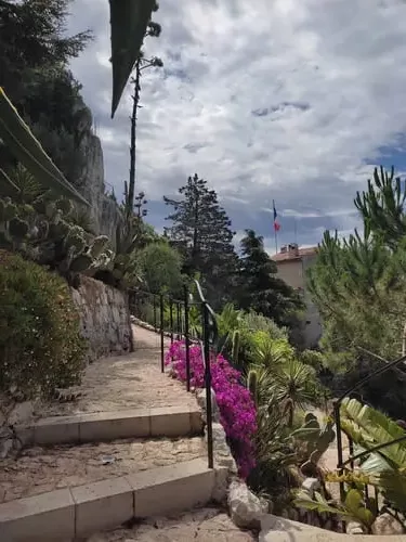 Stone path through cacti and flowers at the Jardin Exotique Èze