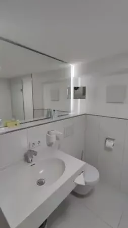 Modern white bathroom at Hotel Palmenhof