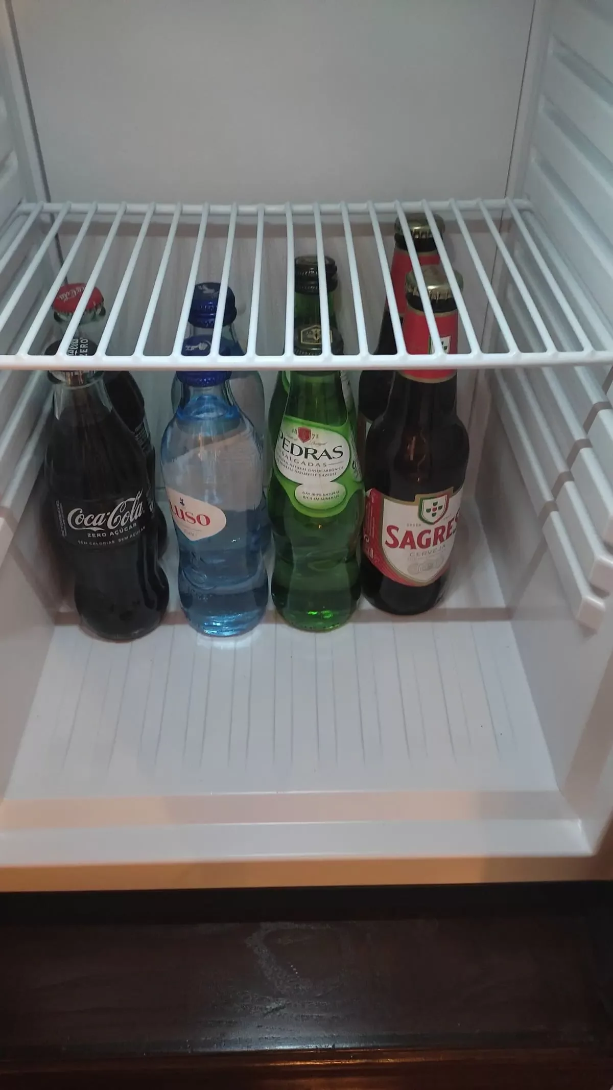 Minibar in room with beer and soda