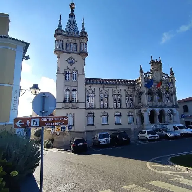 The Sintra Town Hall sports an impressive clock tower surrounded by smaller spires. The tiled roof is typical for the Sintra architecture.