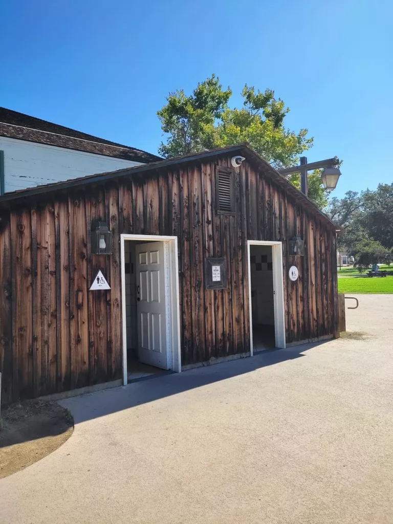 This plain building made of wooden boards at the entrance of Old Town San Diego houses restrooms