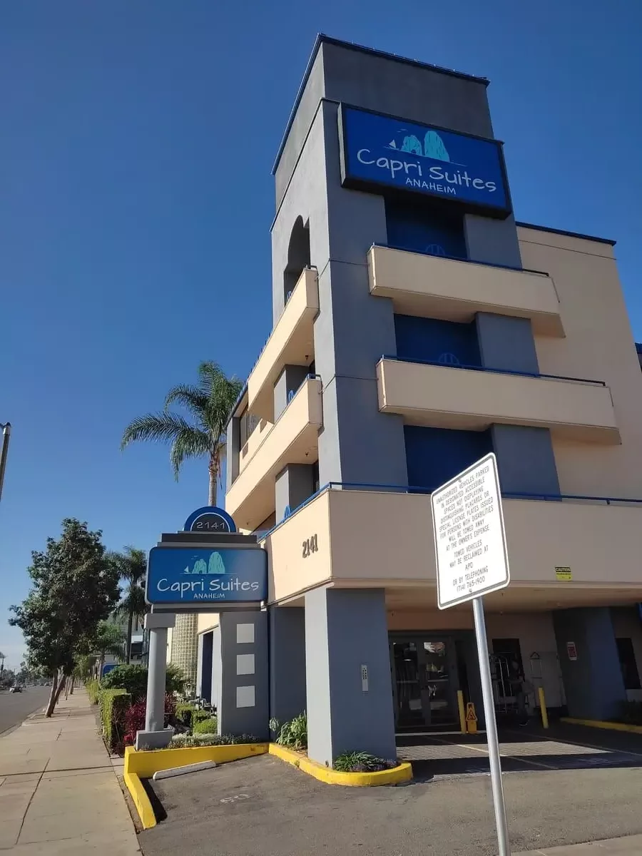 Entrance to motel with large sign Capri Suites Anaheim on Harbor Boulevard