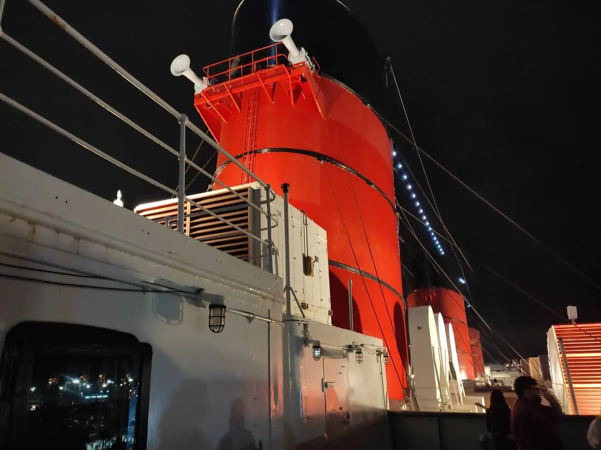 Queen Mary's iconic red chimneys seem to glow in the night