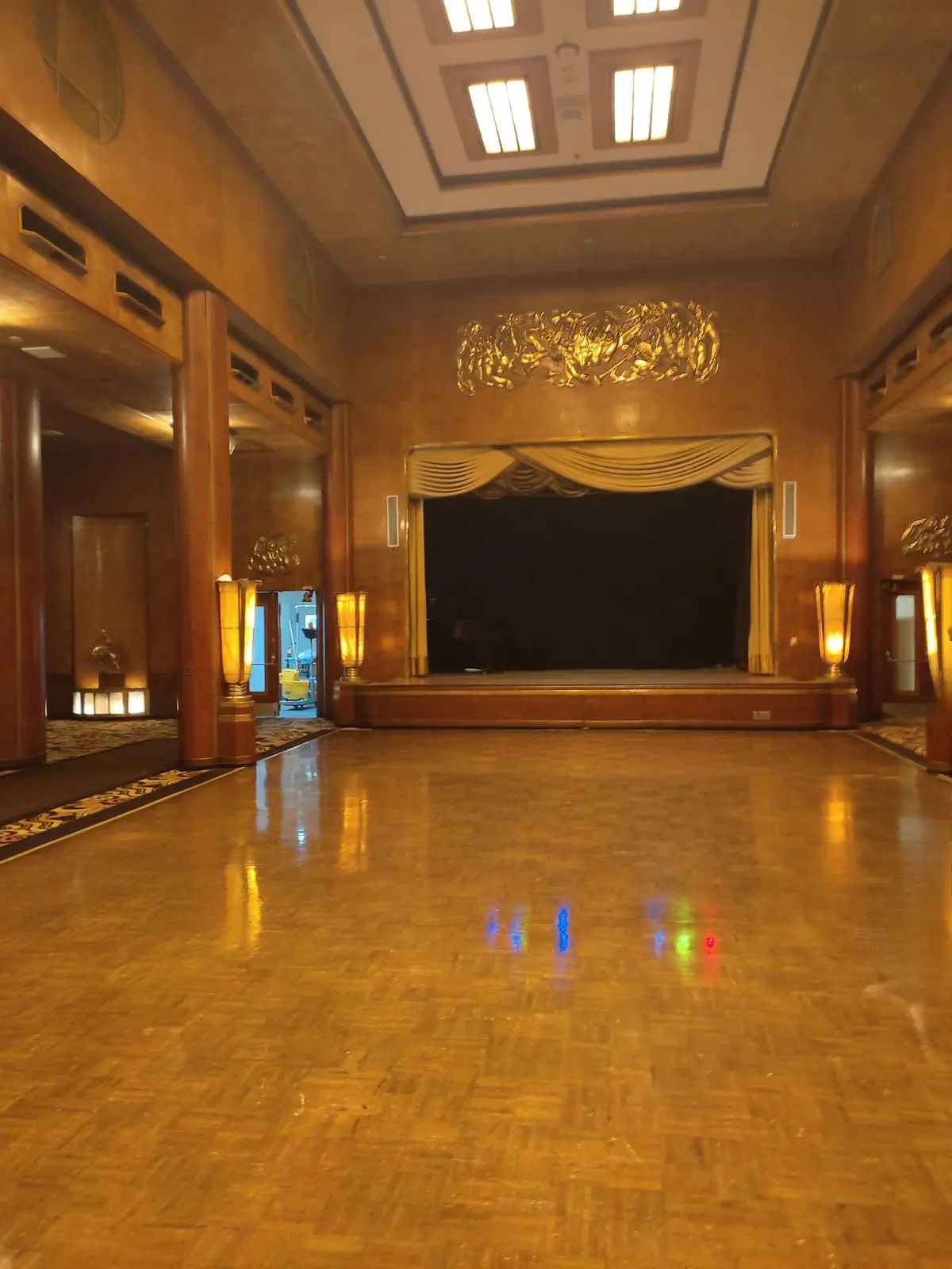 Beautifully decorated Queen's room with dance floor in the middle and stage at the end