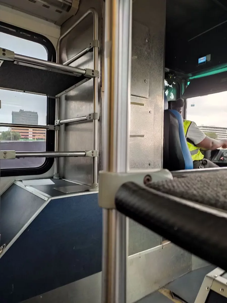 Inside the LAX bus shuttle are racks to put suitcases on.