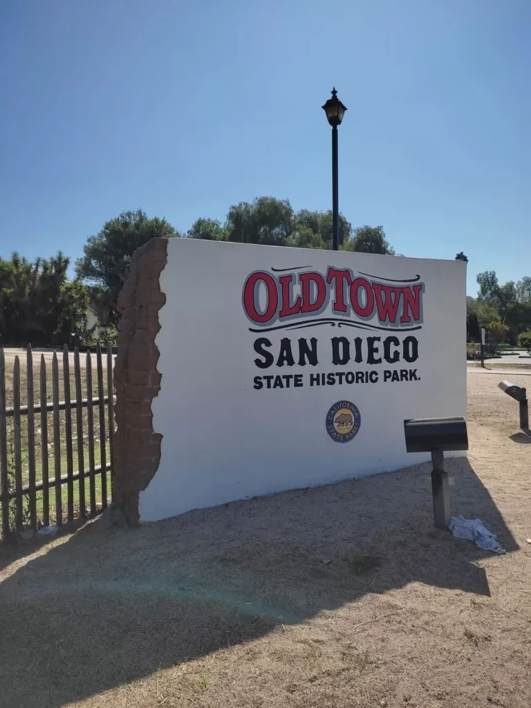 White wall with writing Old Town San Diego State Historic Park at entrance to park