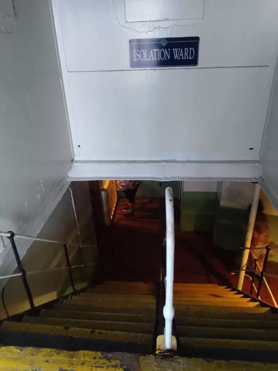 Steps going down to a dark and spooky hallway leading to Queen Mary's Isolation Ward