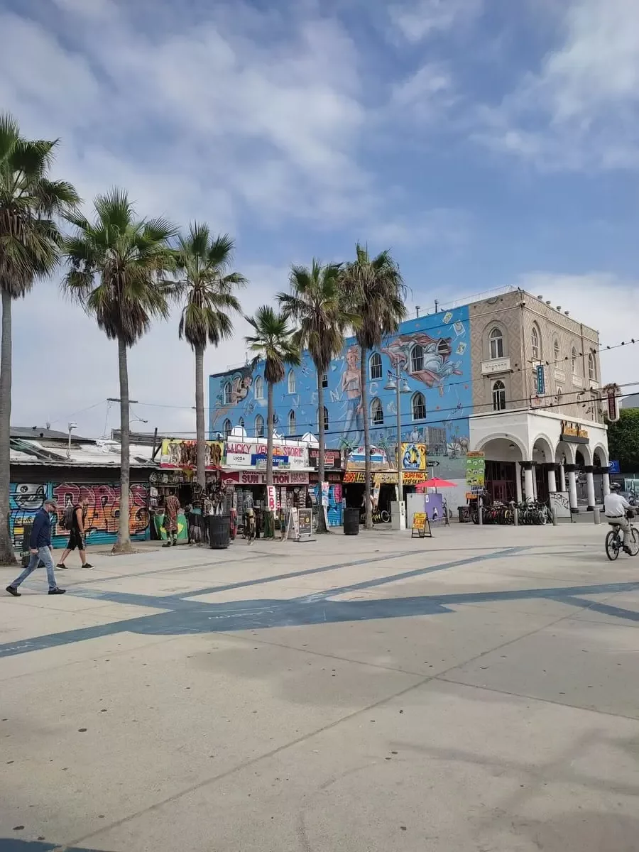 Venice Beach with palm trees, cheap souvenir shops, and a colorful building
