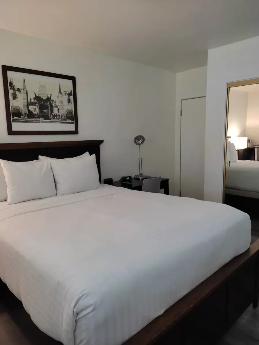 Bed and small desk at the Magic Castle Hotel