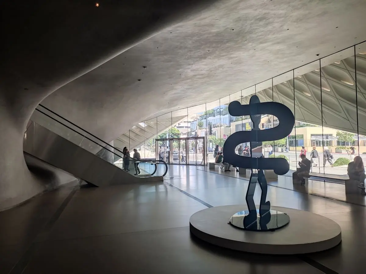 Lobby of the Broad with escalators up to exhibits and metal sculpture