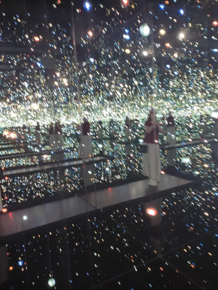 Inside Yayoi Kusama's Infinity Mirrored Room at the Broad Museum in Downtown LA. As you stand on a rectangular platform mirrors and blinking lights transform your surroundings