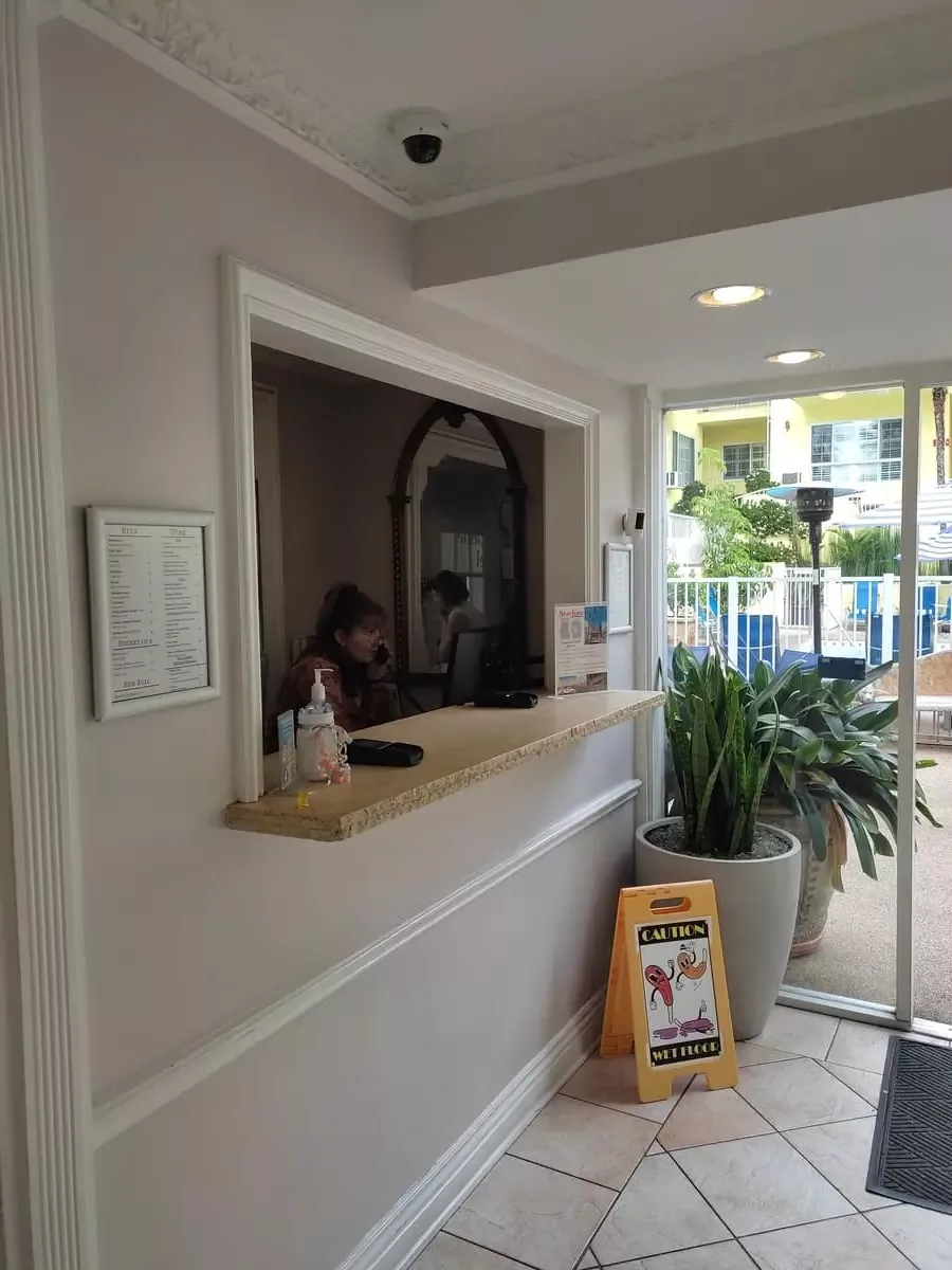 Small, airy reception area with view of interior courtyard at Magic Castle Hotel