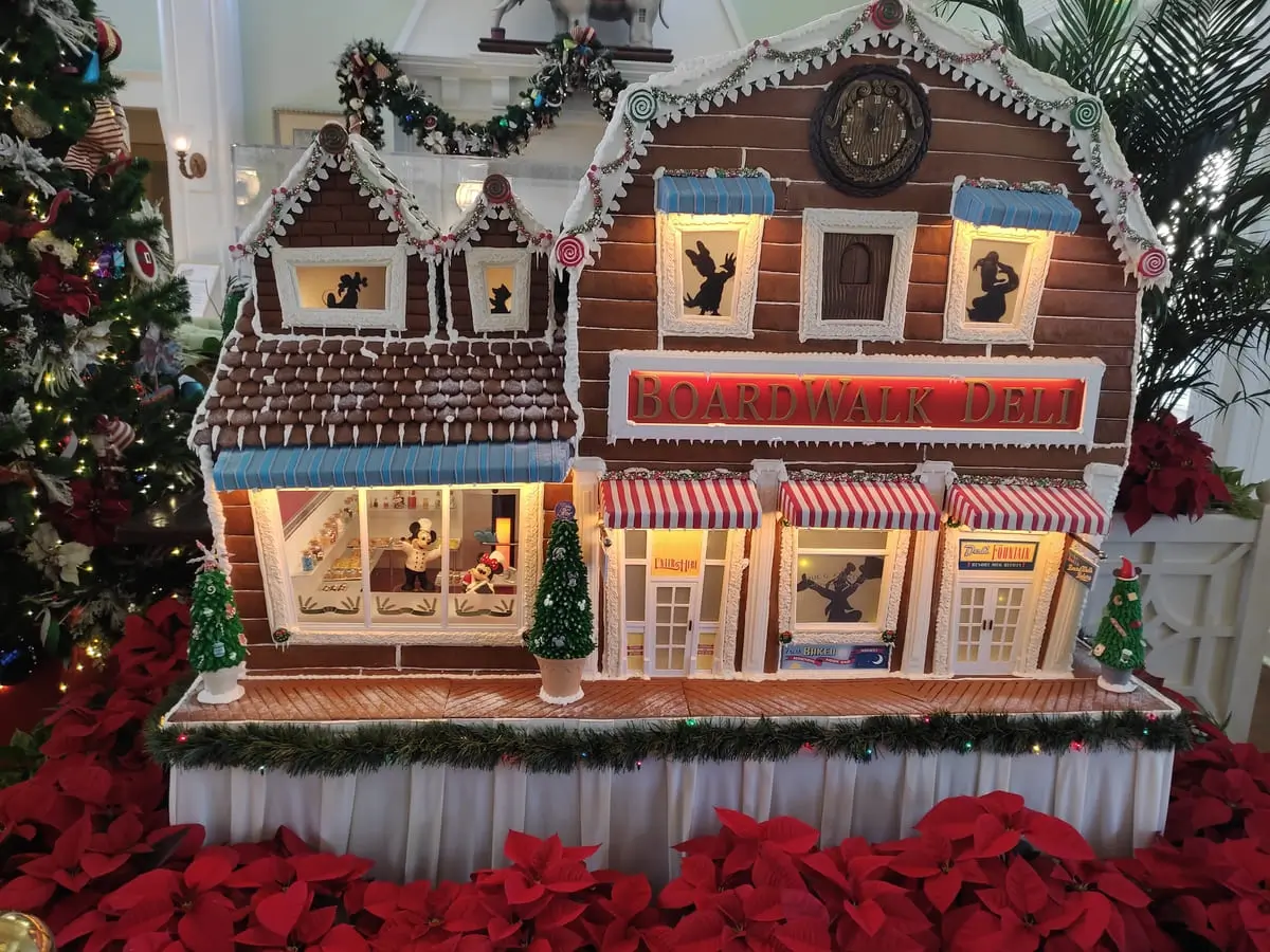 Gingerbread House at Disney's Boardwalk Inn: model of Boardwalk Deli with silhouettes of Disney characters in windows and Chefs Mickey and Minnie in the kitchen