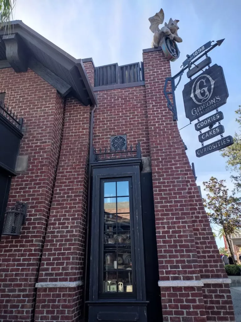 A small gargoyle perches on top of Gideon's Bakehouse in Disney Springs