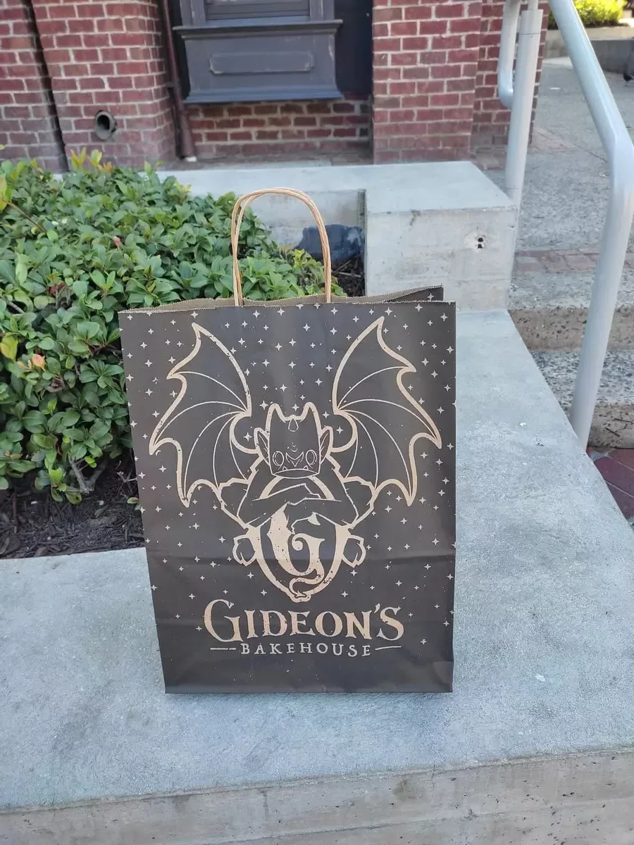 Large paperbag with writing "Gideon's Bakehouse" and a picture of a gargoyle