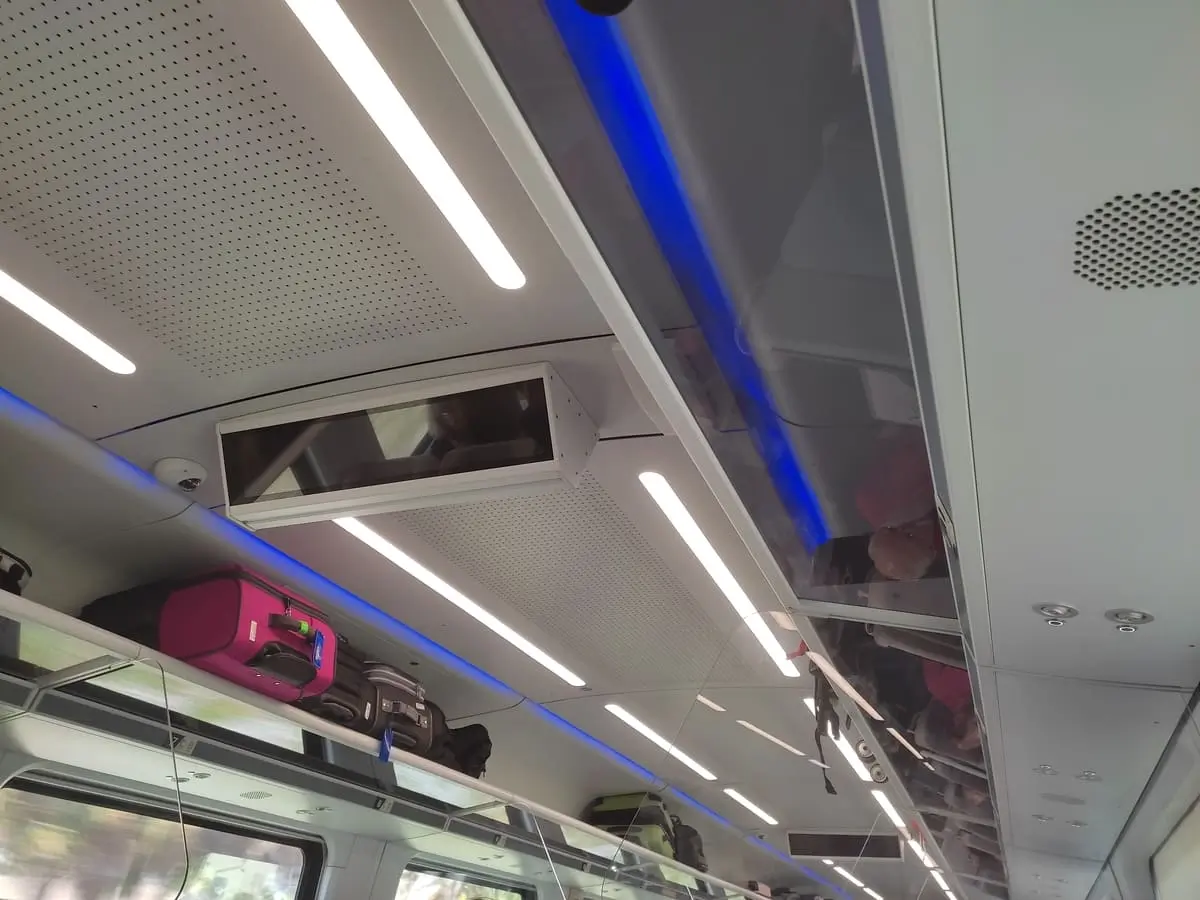 Luggage rack on Brightline Train and blank overhead screens