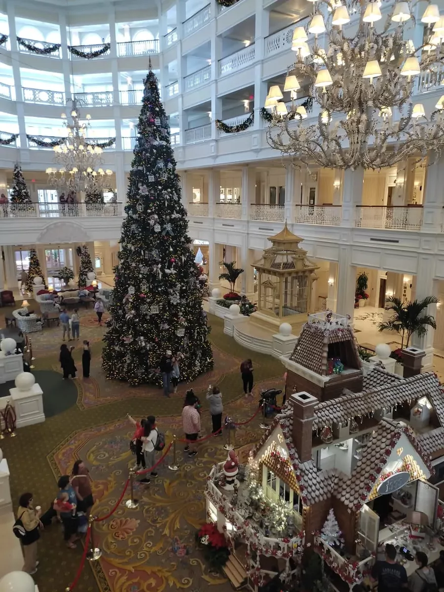 Open lobby of Disney's Grand Floridian Hotel with huge Christmas Tree and Gingerbread House