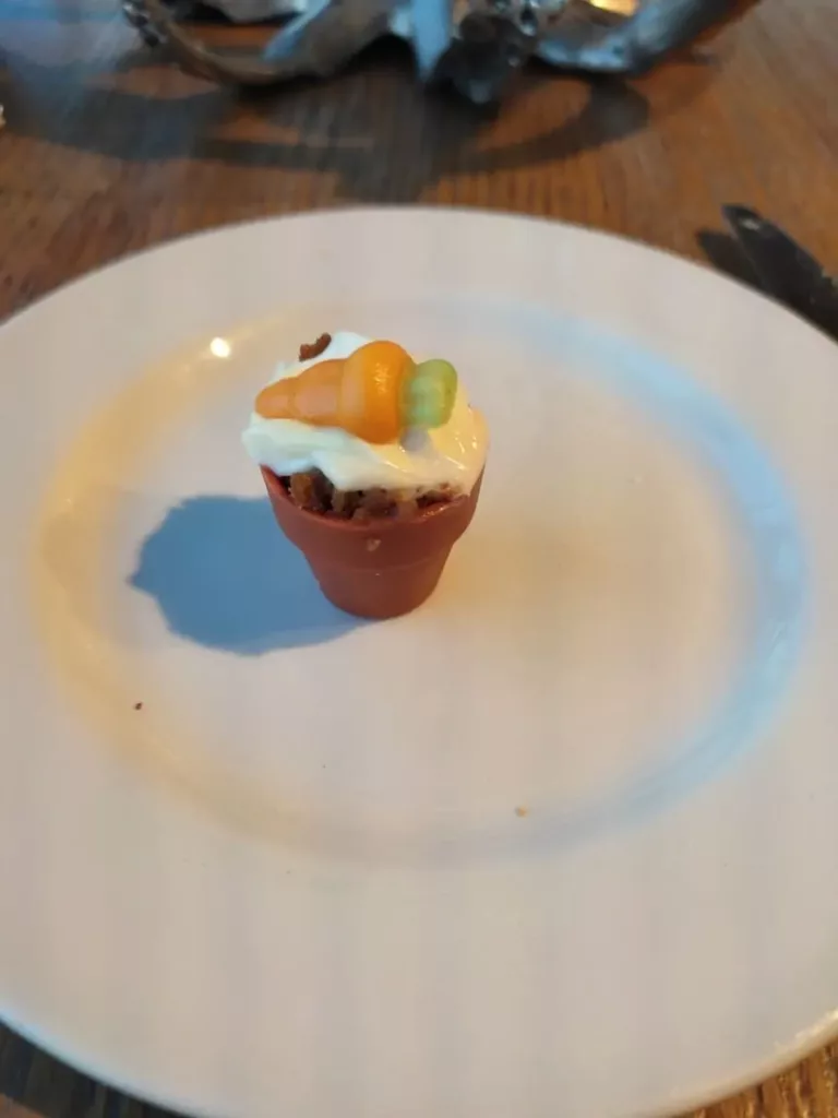 White plate with a small edible replica of a flower pot