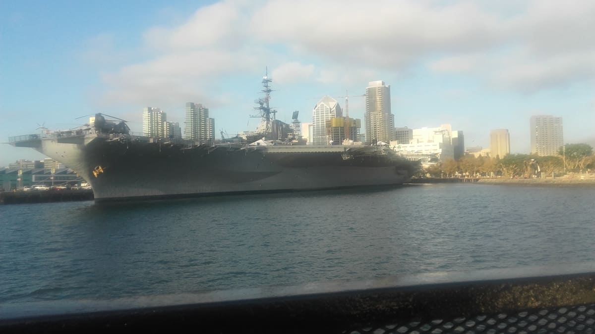 USS Midway with San Diego skyline in background