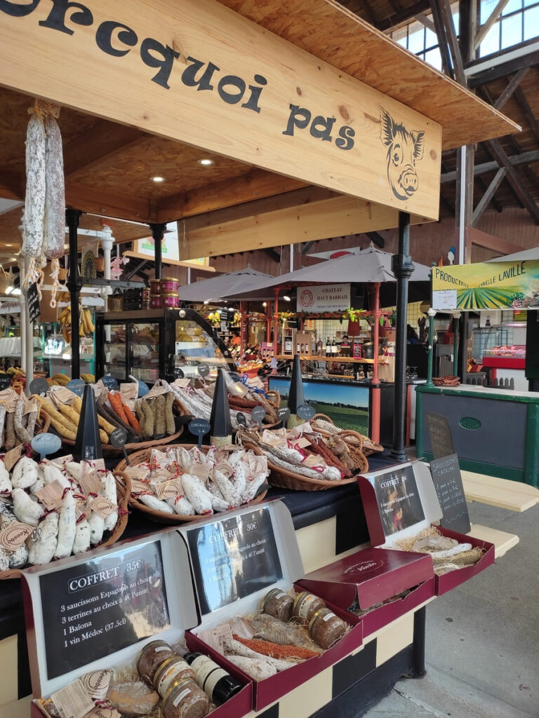 Stall selling cured meats in market hall of Soulac