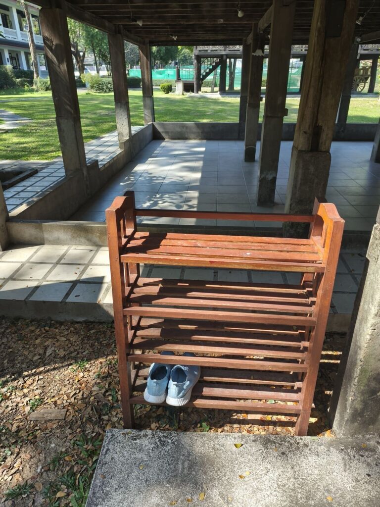Rack for shoes next to wooden building