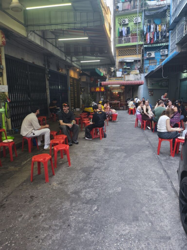 Seating on low plastic chairs at curry restaurant
