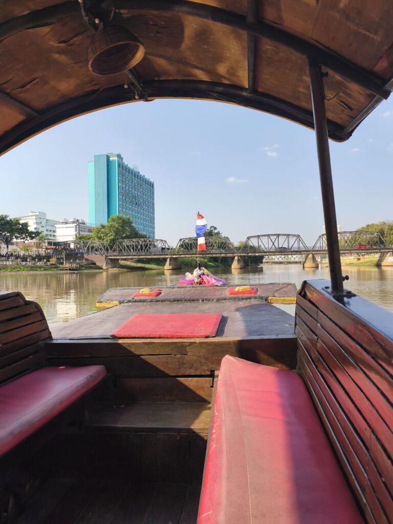 Inside of Ping River boat with red benches and canopy