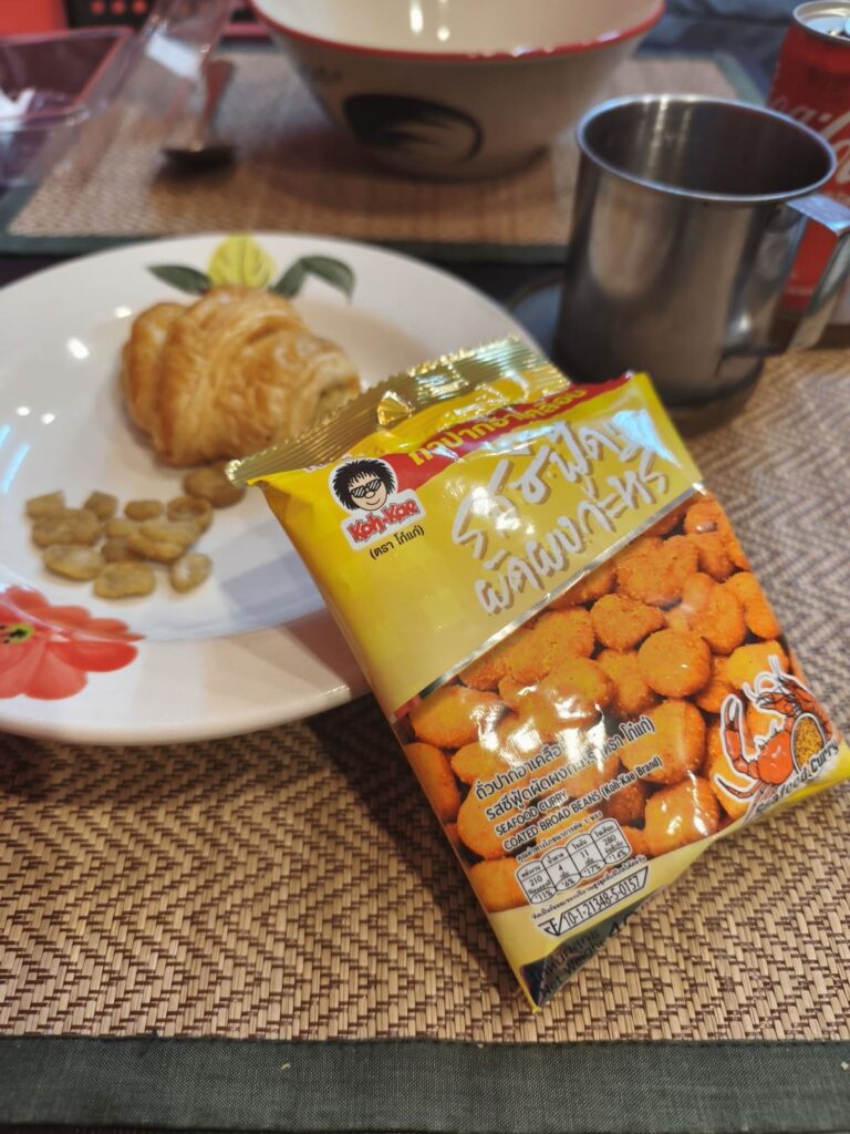 Plate with pastry and small bag with broad beans