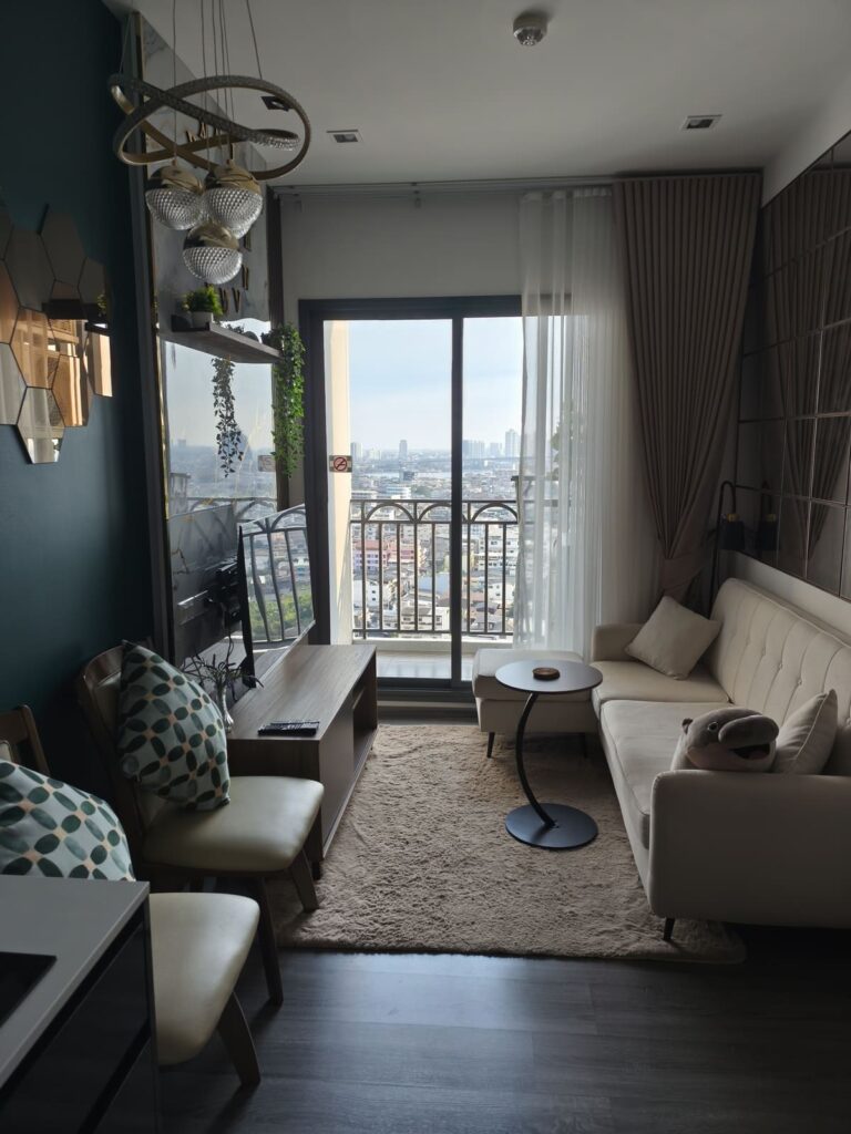 Living Area of AirBnB with sofa and door to balcony