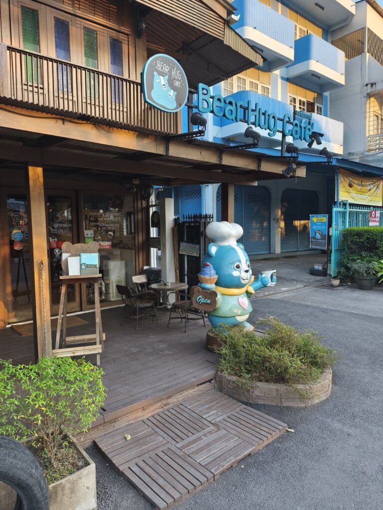 Cafe with statue of cute blue bear in front of it