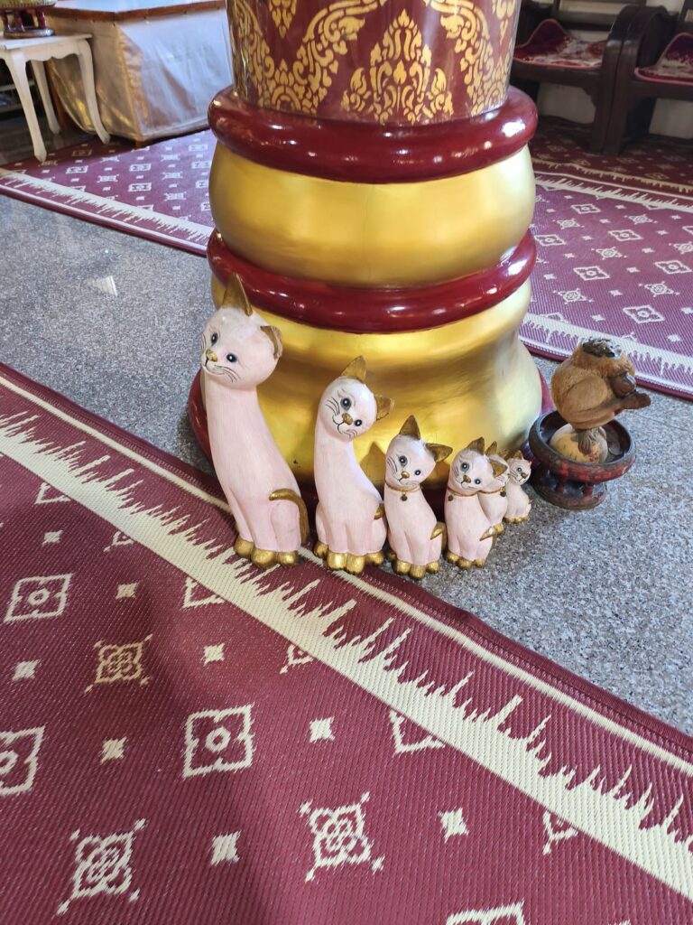 Statues of cute cats at a temple