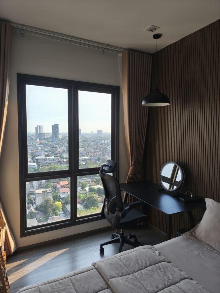 Bedroom with desk and chair and large window