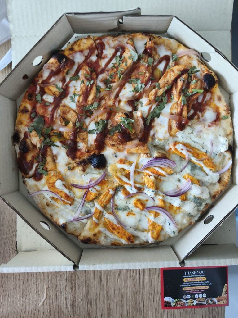 Mid-sized pizza, half BBQ, the other half Buffalo Blaze