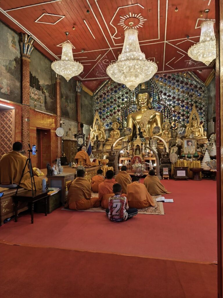 Temple interior with chanting monks