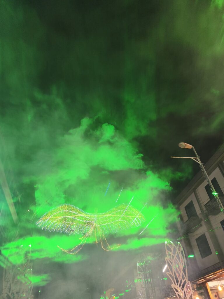 Green laser and smoke in sky