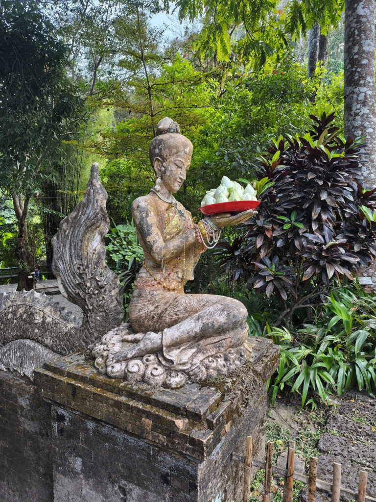 Statue with fruit offerings