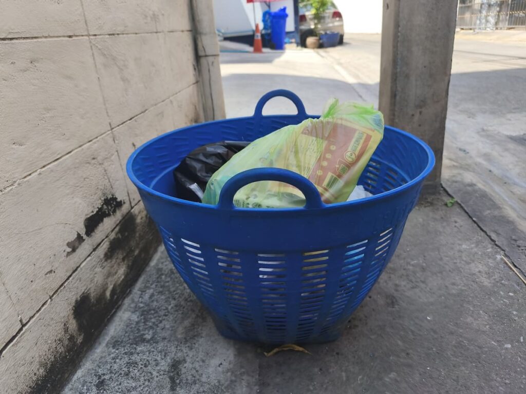 Blue Basket used as outdoor trash can