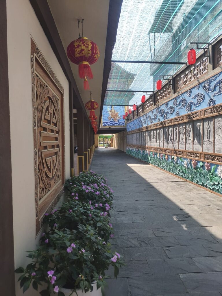 Entry to Nam Son with murals on one side